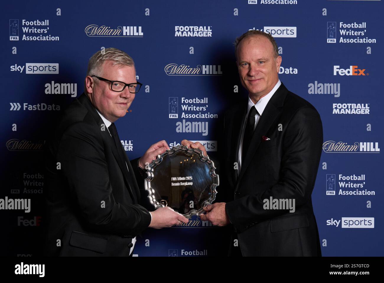 Dennis Bergkamp `(right) is presented his award by chairman of the FWA